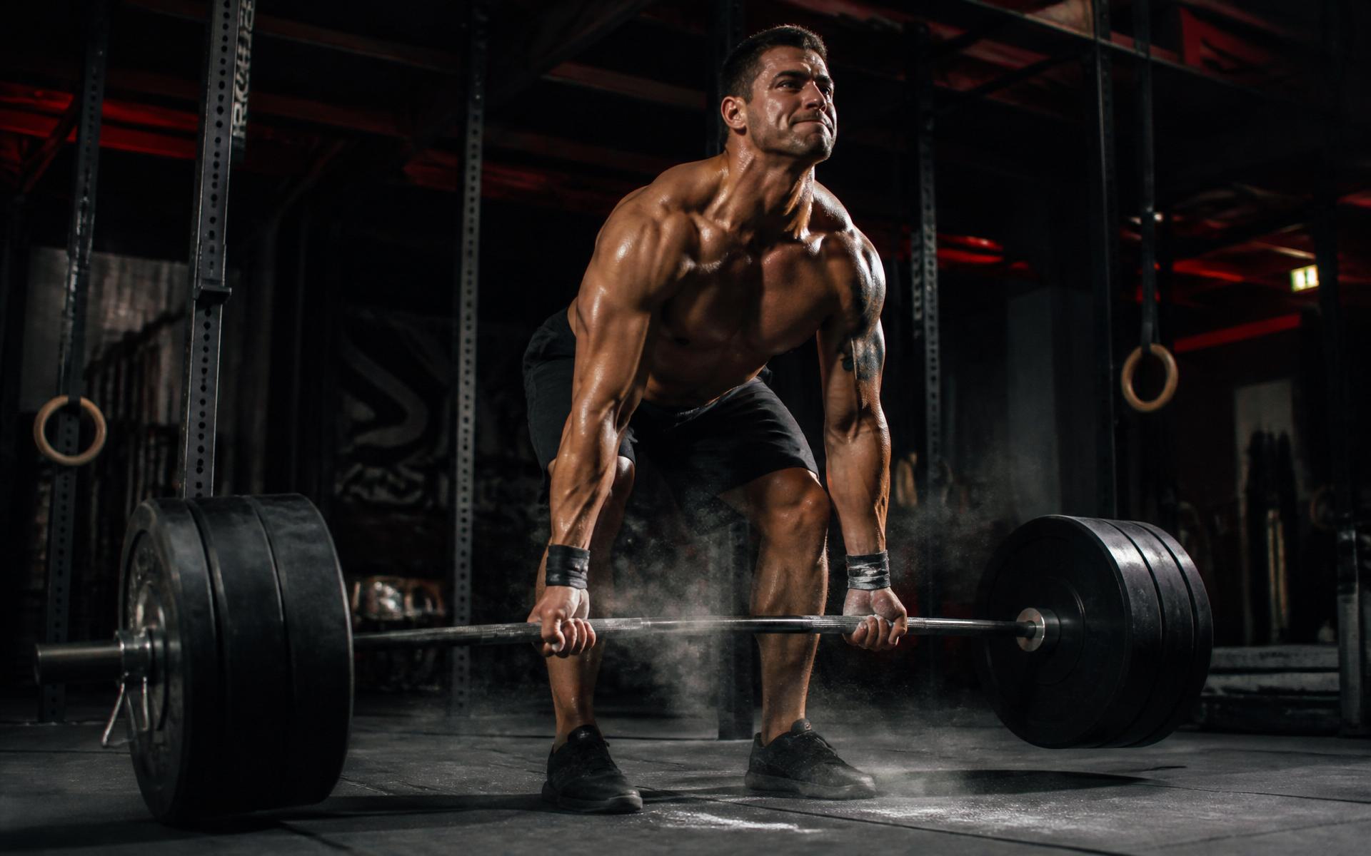 Athlete deadlifting heavy barbell at Ri-Shape Gym